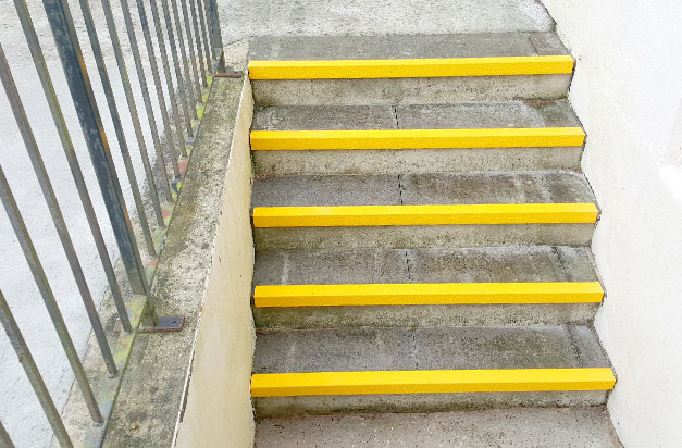 Basement stairway entrance anti-slip stair nosing installation.